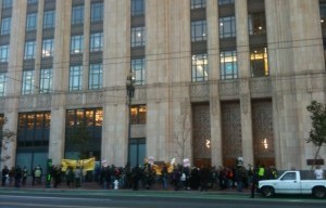 “Stop the Corporate Greed” Reads Sign Carried By SF Supervisor At Market Street Rally